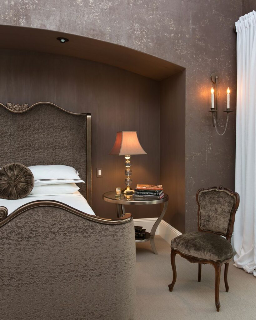 Beautiful beaded wall sconces featuring two candlestick lights installed in Peg's Master Bedroom