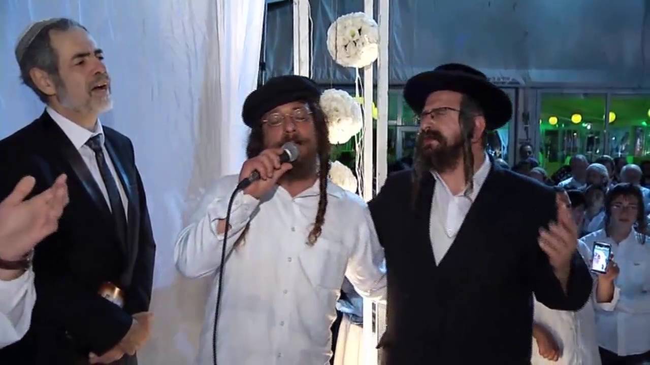 Meilech Kohn blessing groom and bride with Birchas Kohanim under the chupa