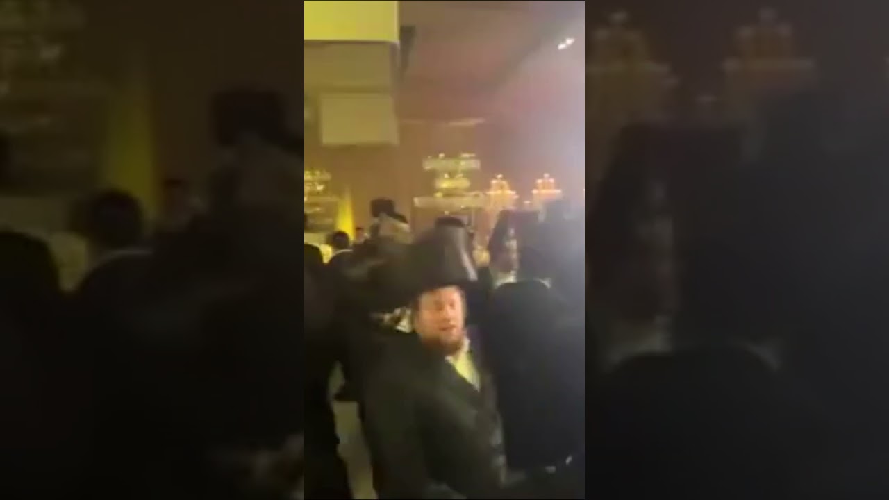 People Dancing and Spinning Under Vibrant Bar Lights