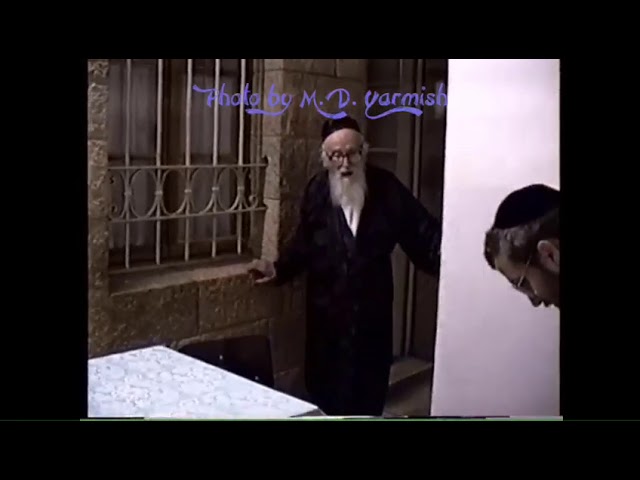 Rav Shlomo Zalman Auerbach ztz"l giving an upsherin in 1994 - M.D. Yarmish Collection