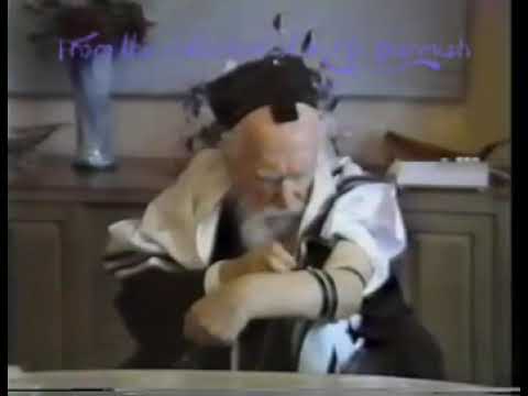 Harav Moshe Feinstein ztz"l putting on Tefillin - Credit: M.D. Yarmish Collection