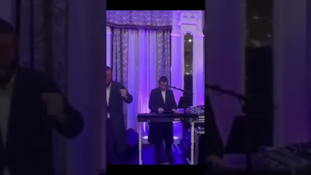 Energetic Dance Party Featuring Men and a Young Boy in Hotel Room