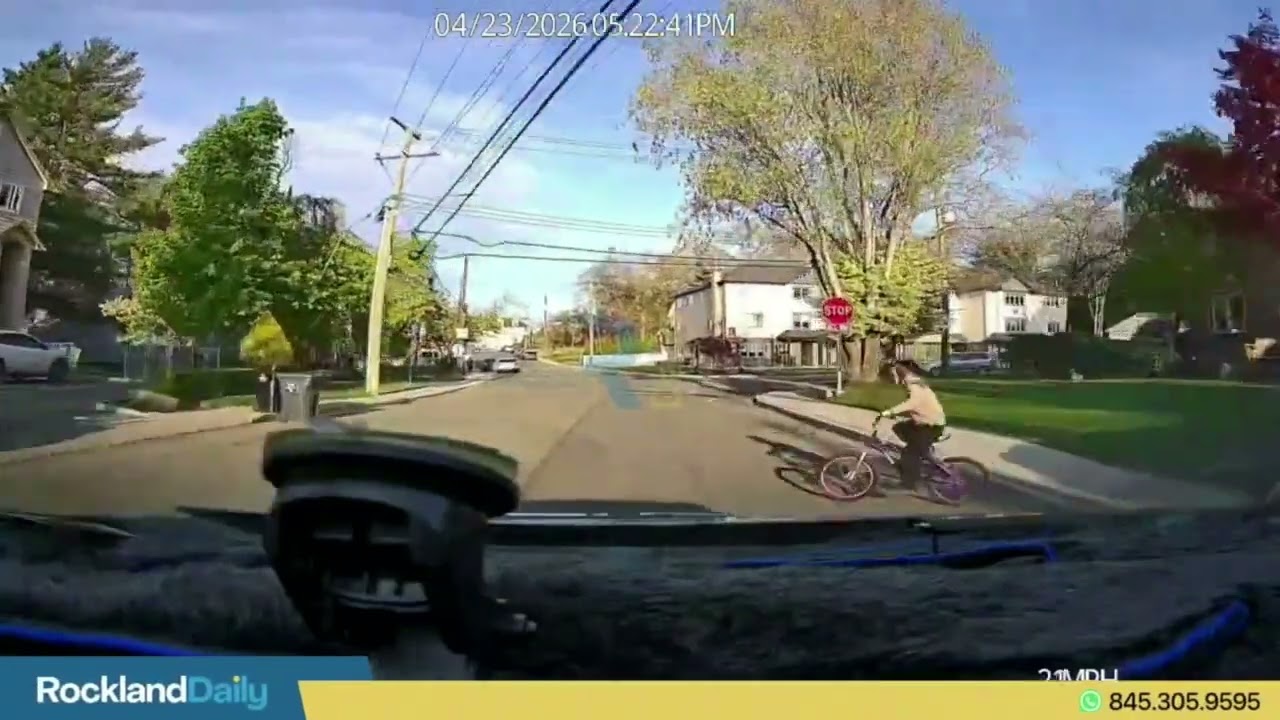 Taxi driver shows a child on a bike suddenly popping out between parked cars into the road