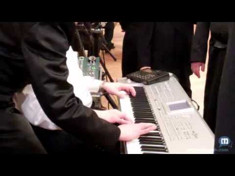 Three Hands Playing On Keyboard