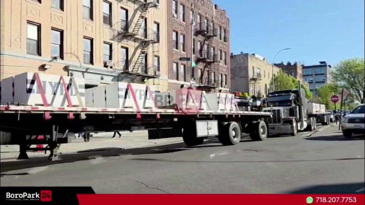 Two tractor-trailers on 14th Ave carried new NYPD concrete security barriers.